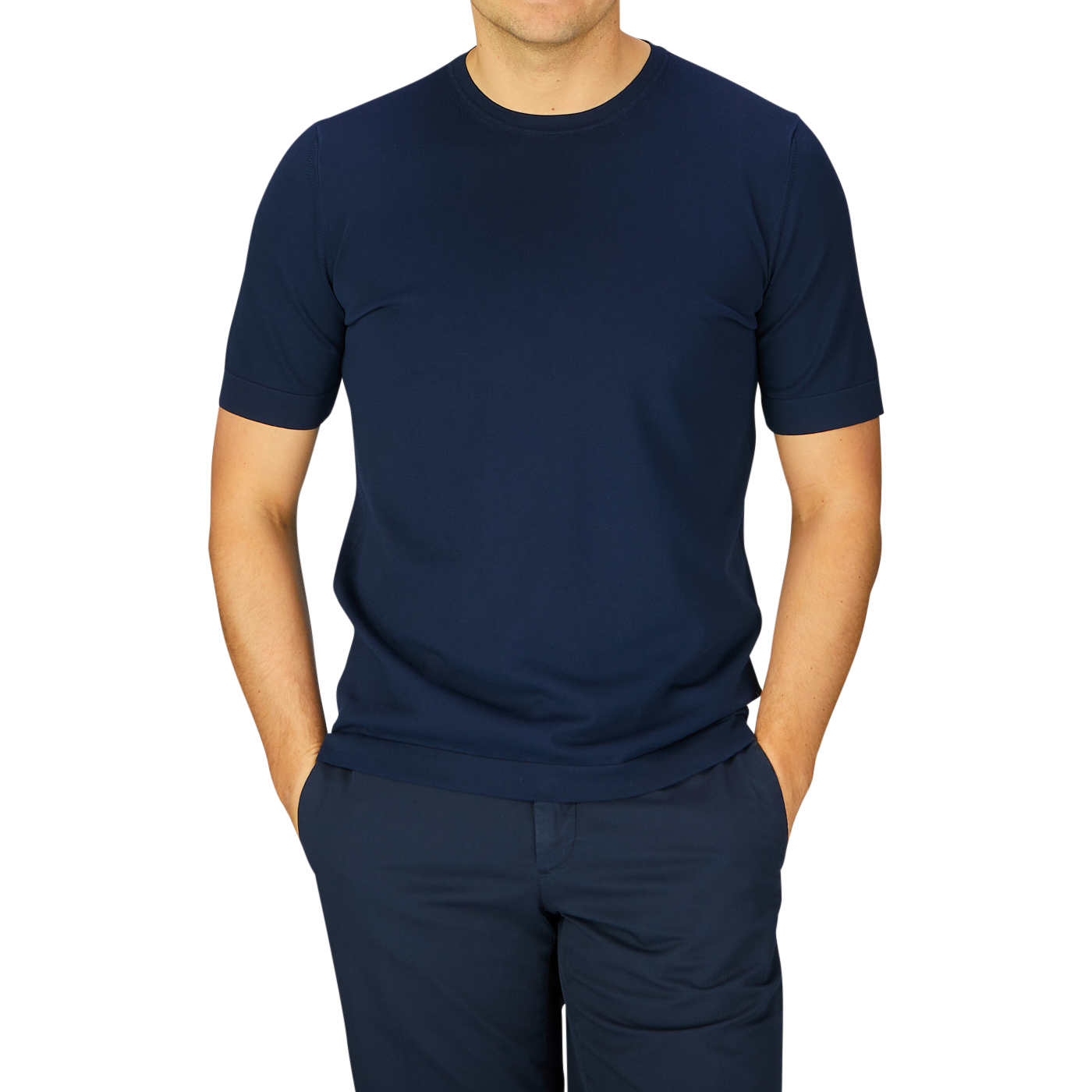 Man wearing a Gran Sasso navy blue organic cotton knitted t-shirt and matching pants standing against a grey background.