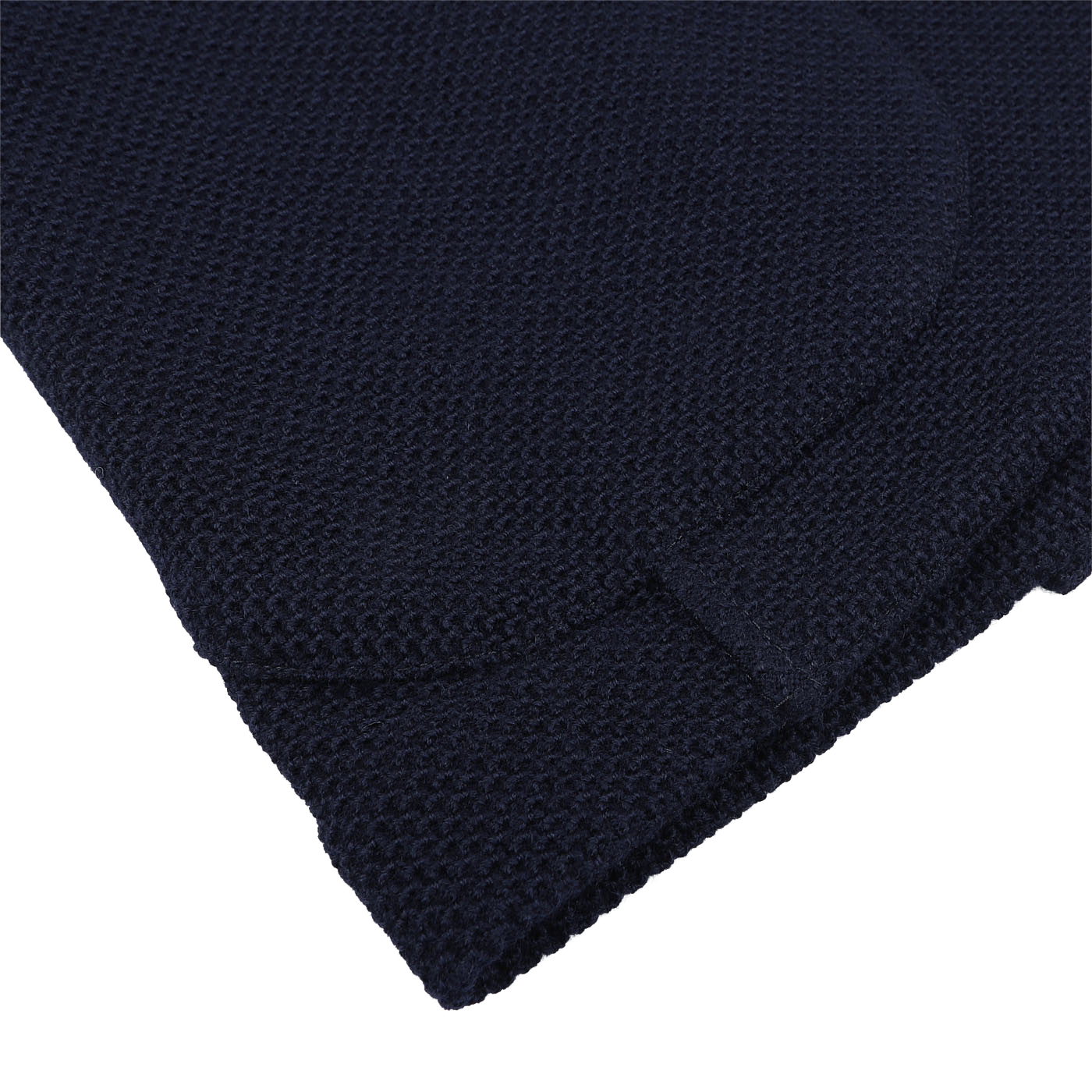 Close-up of a dark blue textured fabric with a rounded edge, reminiscent of the luxurious pure virgin wool used in Gran Sasso's Navy Blue Virgin Wool Sartorial Jacket.