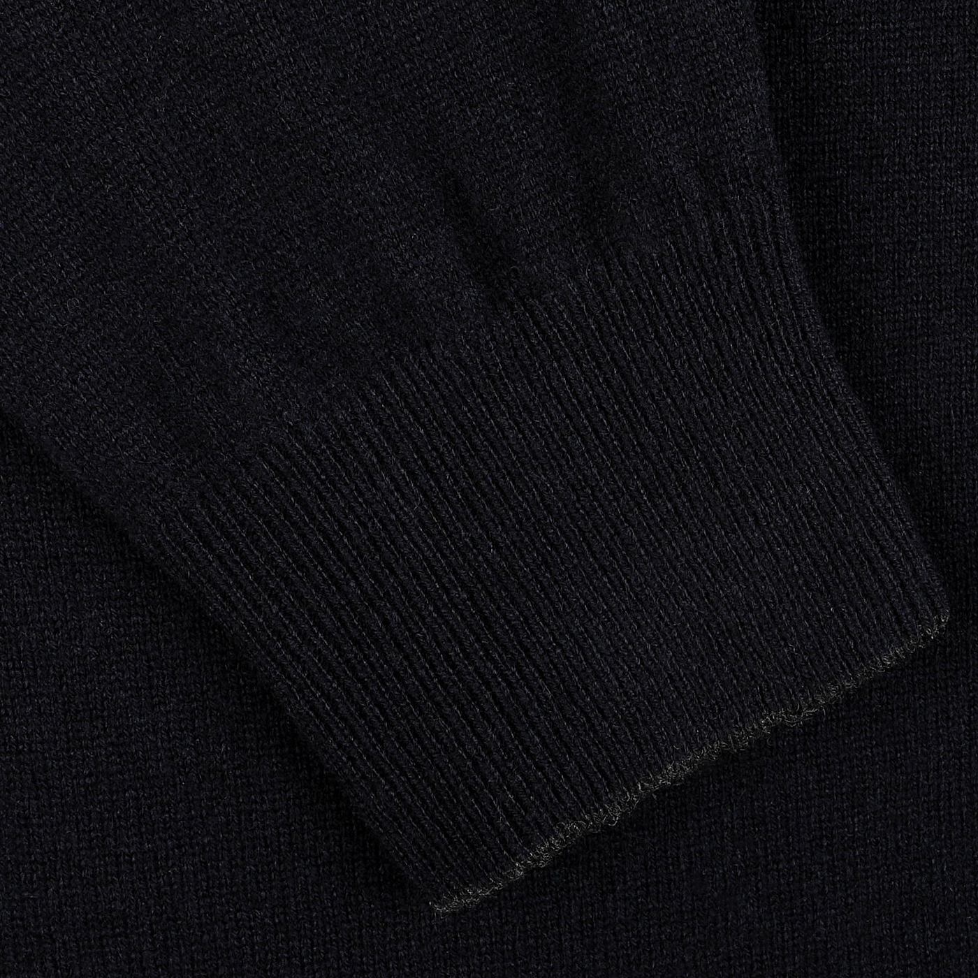 Close-up of a navy blue wool cashmere zip cardigan sleeve with ribbed cuffs, showcasing the elegance of premium knitwear from Gran Sasso.