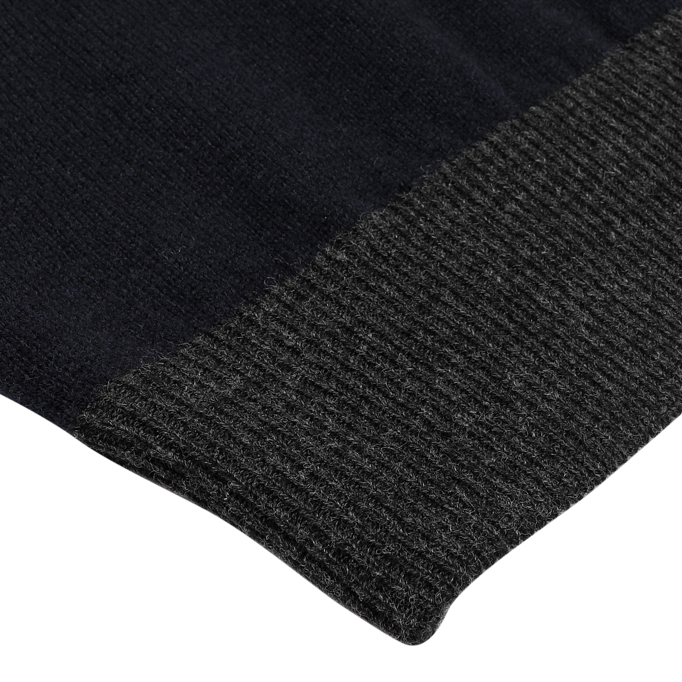 Close-up of a navy blue wool cashmere zip cardigan with a ribbed texture and contrasting gray knit edge, highlighting the exquisite craftsmanship of premium knitwear from Gran Sasso.