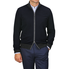 A person stands casually with one hand in their pocket, wearing Gran Sasso's Navy Blue Wool Cashmere Zip Cardigan over a striped shirt and navy pants.