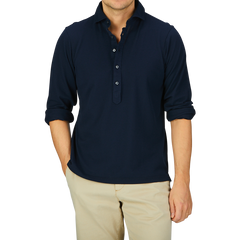 Man wearing a navy Cotton Jersey Popover Gran Sasso shirt and beige trousers.