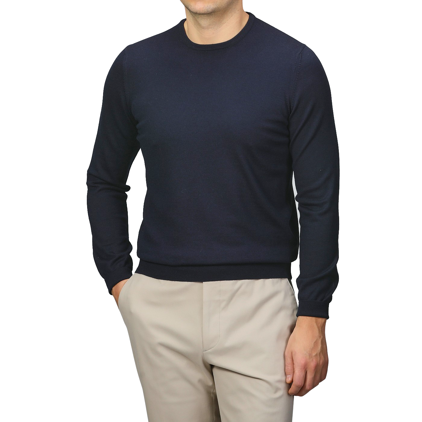 A person wearing a Gran Sasso Navy Extra Fine Merino Crew Neck and beige pants stands against a gray background, offering a touch of comfort and warmth to any wardrobe.