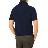 The back view of a man wearing a Gran Sasso Navy Fresh Cotton Mesh Polo Shirt.