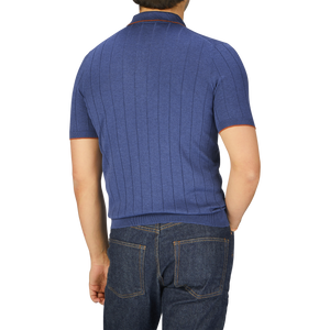 A man wearing a dark blue Gran Sasso Knitted Silk Zip Polo Shirt and jeans is seen from behind.