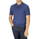 A man dressed in a Gran Sasso dark blue knitted silk zip polo shirt and jeans.
