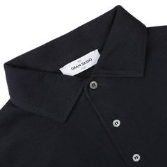 Close-up of the Navy Merino Wool One-Piece Collar Polo Shirt by Gran Sasso, crafted from extra-fine merino wool and featuring buttons with a visible brand label reading "Gran Sasso.