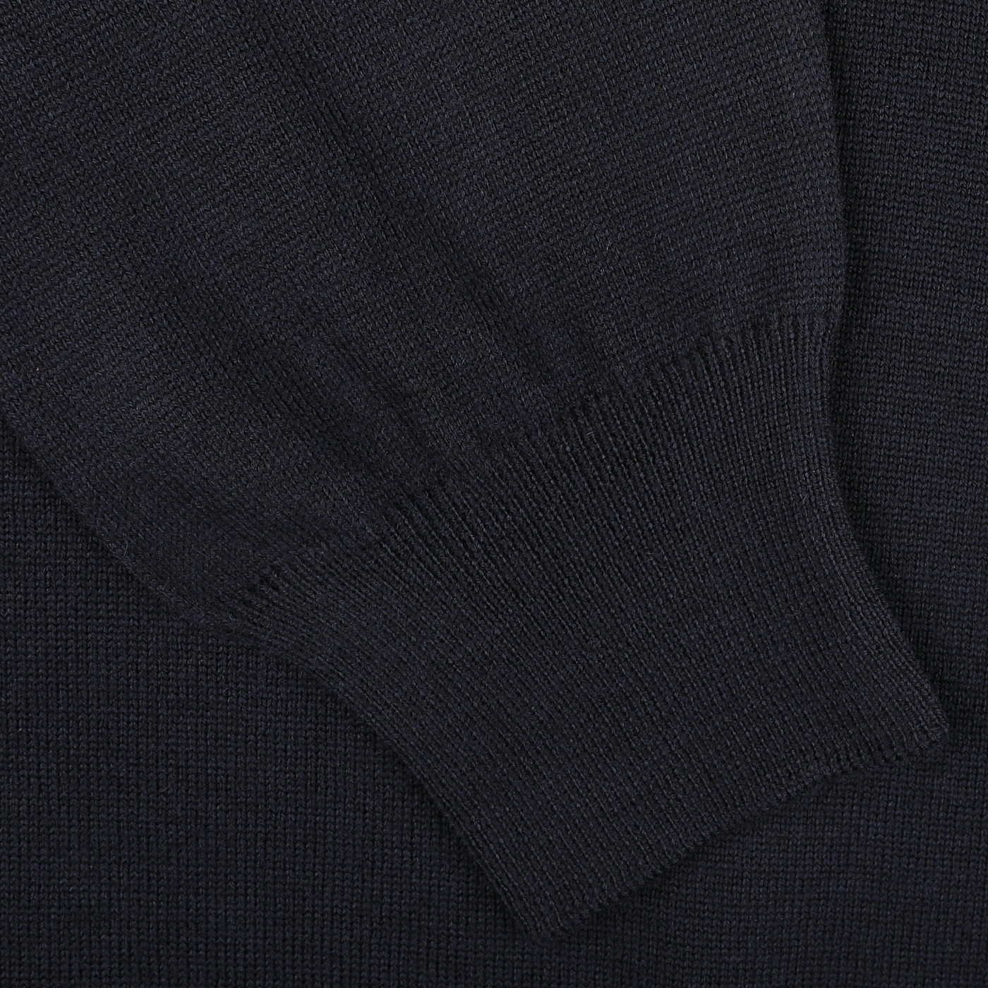 Close-up of a navy-colored, extra-fine merino wool knit fabric from the Gran Sasso Navy Merino Wool One-Piece Collar Polo Shirt, showcasing the ribbed cuff of a long sleeve.