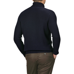 A person wearing the Gran Sasso Navy Rain Wool Rib Roll Neck sweater and brown pants, viewed from the back.