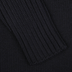 Close-up of a navy blue knitted fabric, showcasing a textured, ribbed pattern akin to the refined craftsmanship of Gran Sasso's Navy Rain Wool Rib Roll Neck.