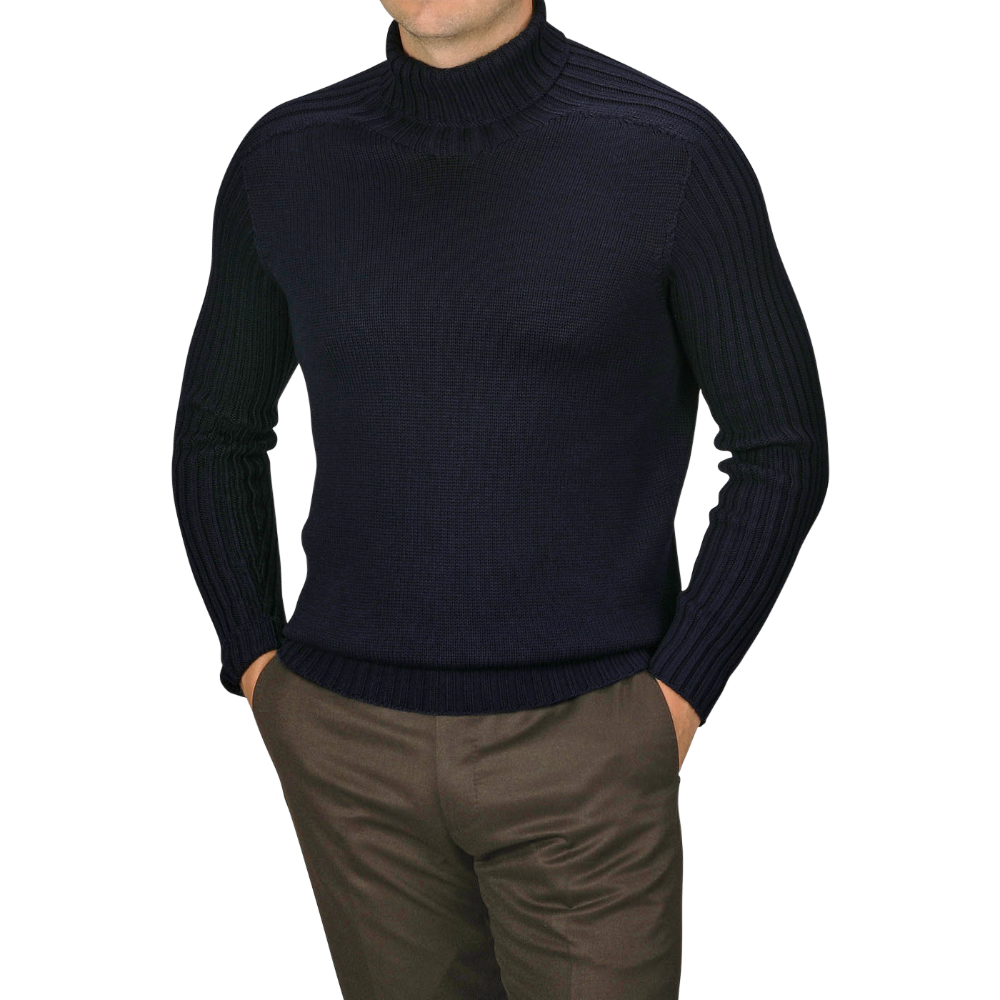 A man wearing a Navy Rain Wool Rib Roll Neck by Gran Sasso and brown pants stands with his hands in his pockets against a plain background.