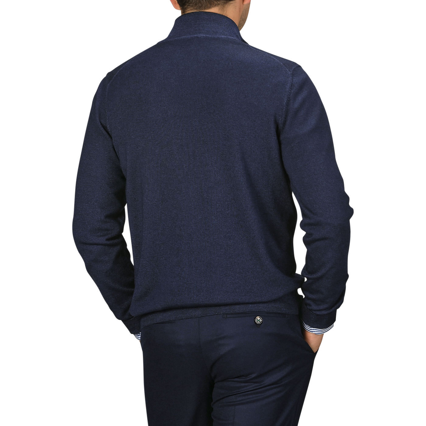 A person in a Navy Vintage Merino Wool Zip Cardigan by Gran Sasso and matching trousers made from pure virgin wool is shown from the back, hands in pockets.