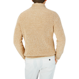 The back view of a man wearing a Gran Sasso oat beige rib-stitch pure cotton 1/4 Zip Sweater in oat beige melange color.