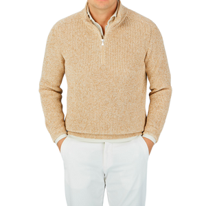 A man wearing a Gran Sasso oat beige rib stitch cotton 1/4 Zip sweater, paired with white pants.