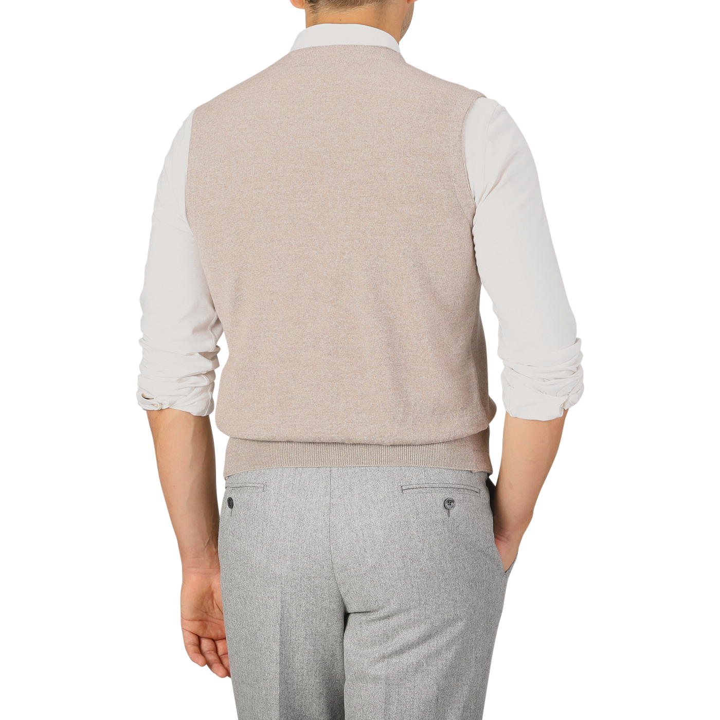 A person wearing a Gran Sasso Oatmeal Beige Knitted Merino Wool Waistcoat over a white shirt and light gray pants is shown from the back.