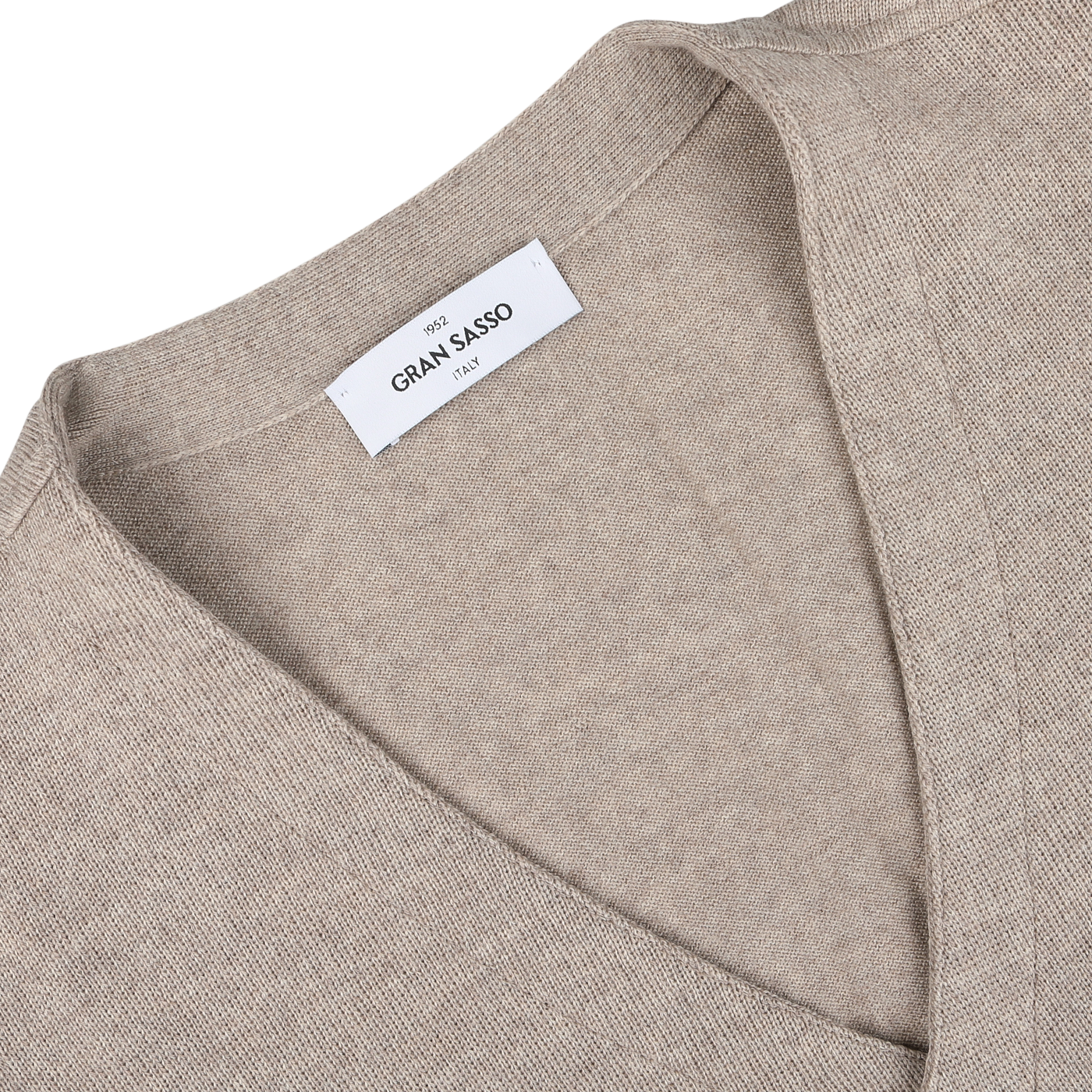 Close-up of an Oatmeal Beige Knitted Merino Wool Waistcoat by Gran Sasso, featuring a white label displaying "Gran Sasso Italy.