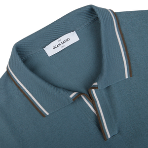 Close-up of a Gran Sasso branded Ocean Blue Fresh Cotton Polo Shirt collar with white and brown stripes detailing.