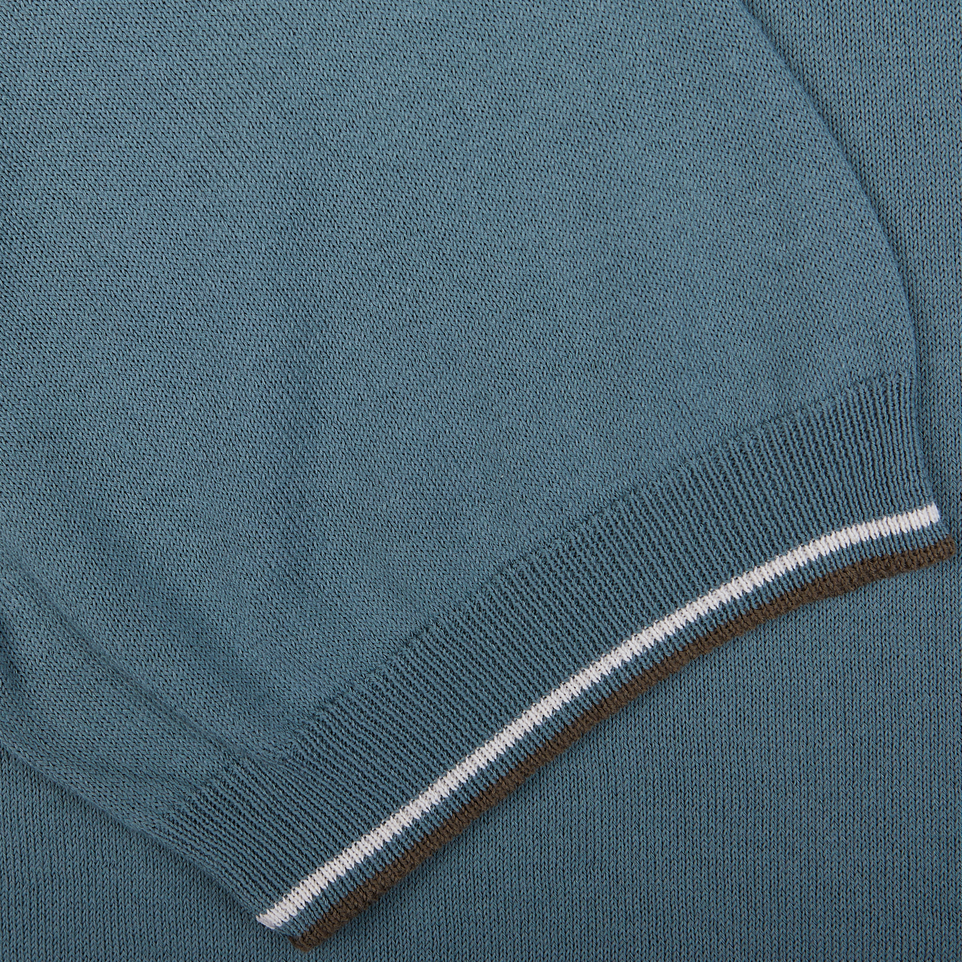 Close-up of a Gran Sasso Ocean Blue Fresh Cotton Polo Shirt with ribbed hem showcasing white and brown striping.