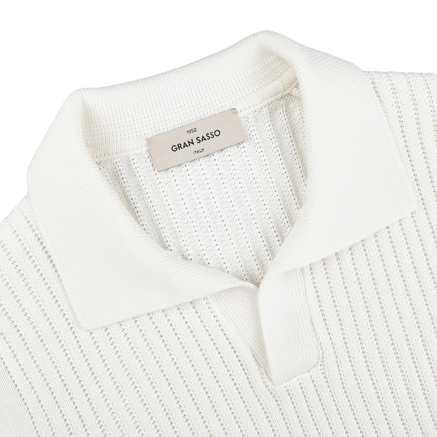 Close-up of an off-white, slim fit ribbed knit polo shirt with a collar and an inner label reading "Gran Sasso," made from soft organic cotton for unmatched comfort.