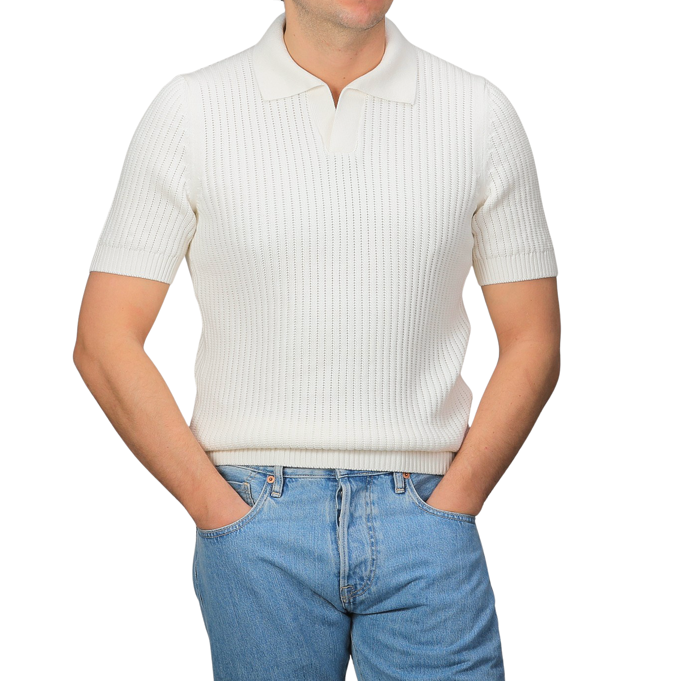 A person dons the Off-White Organic Cotton Polo Shirt by Gran Sasso, featuring a chunky-knit and short sleeves, paired with slim-fit blue jeans, hands in pockets against a grey background.