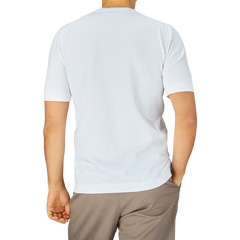 A person facing away from the camera wearing a Gran Sasso Off-White Organic Cotton T-shirt and brown trousers.