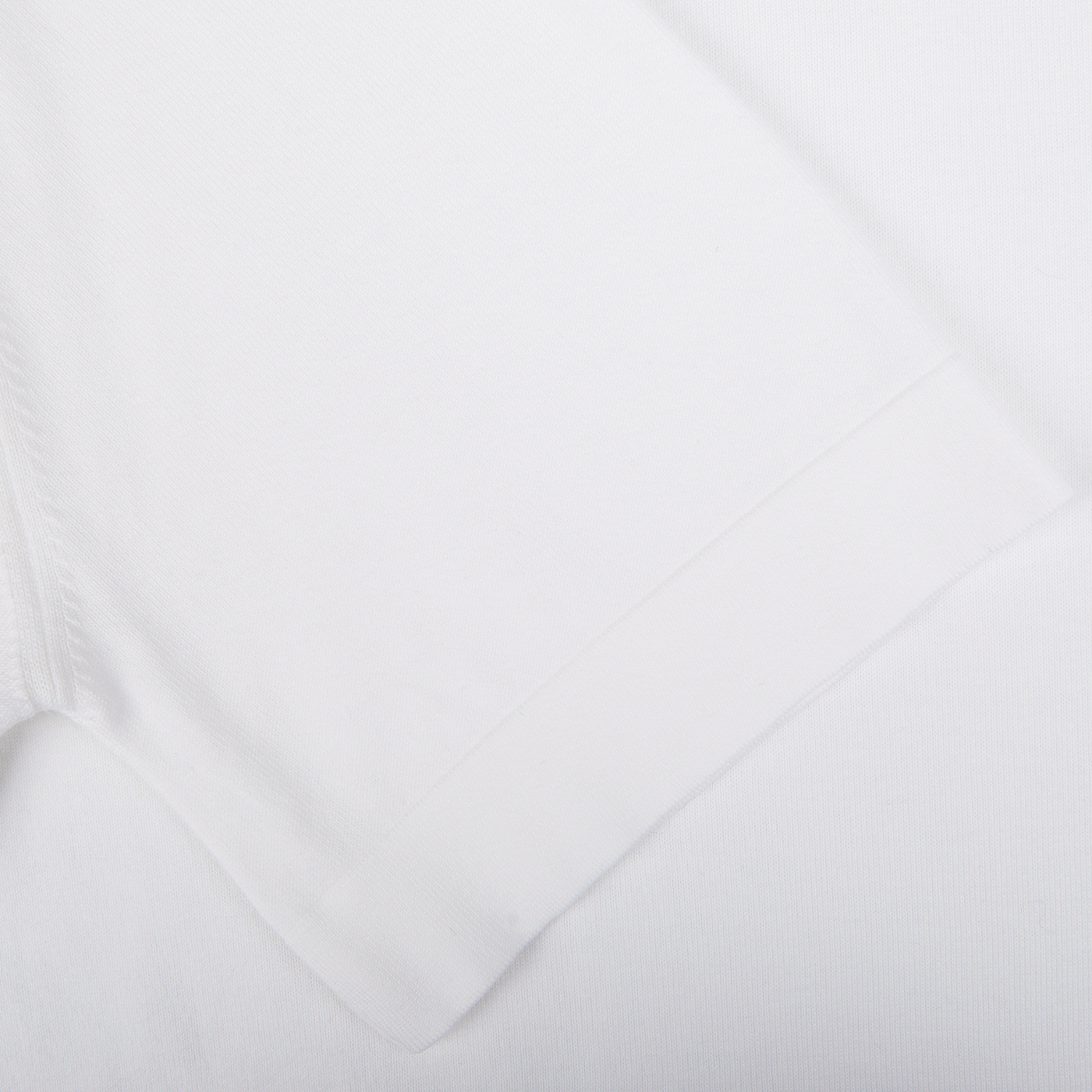 Close-up of a Gran Sasso Off-White Organic Cotton T-shirt fabric texture with a folded edge.