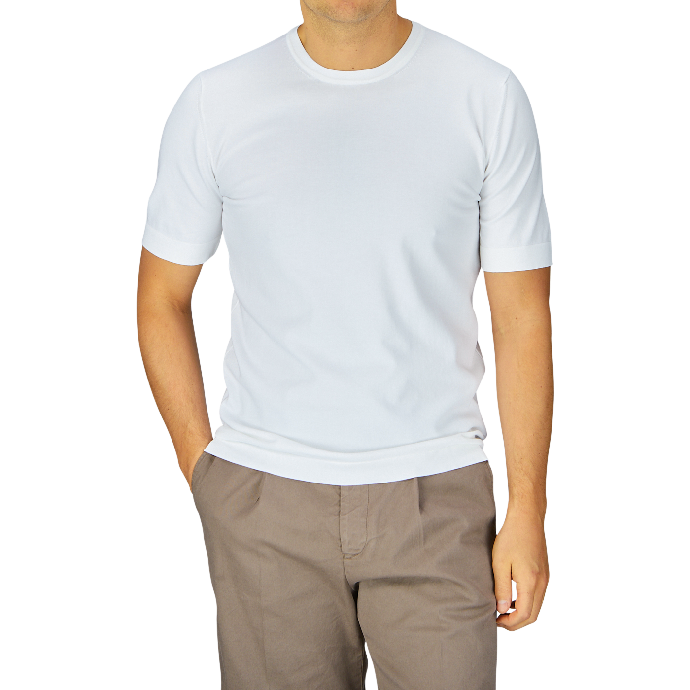 Man in a Gran Sasso Off-White Organic Cotton T-shirt and brown pants standing against a grey background.