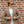 A man in a Gran Sasso Off White Extra Fine Merino Roll Neck and brown blazer is leaning against a brick wall in Italy.