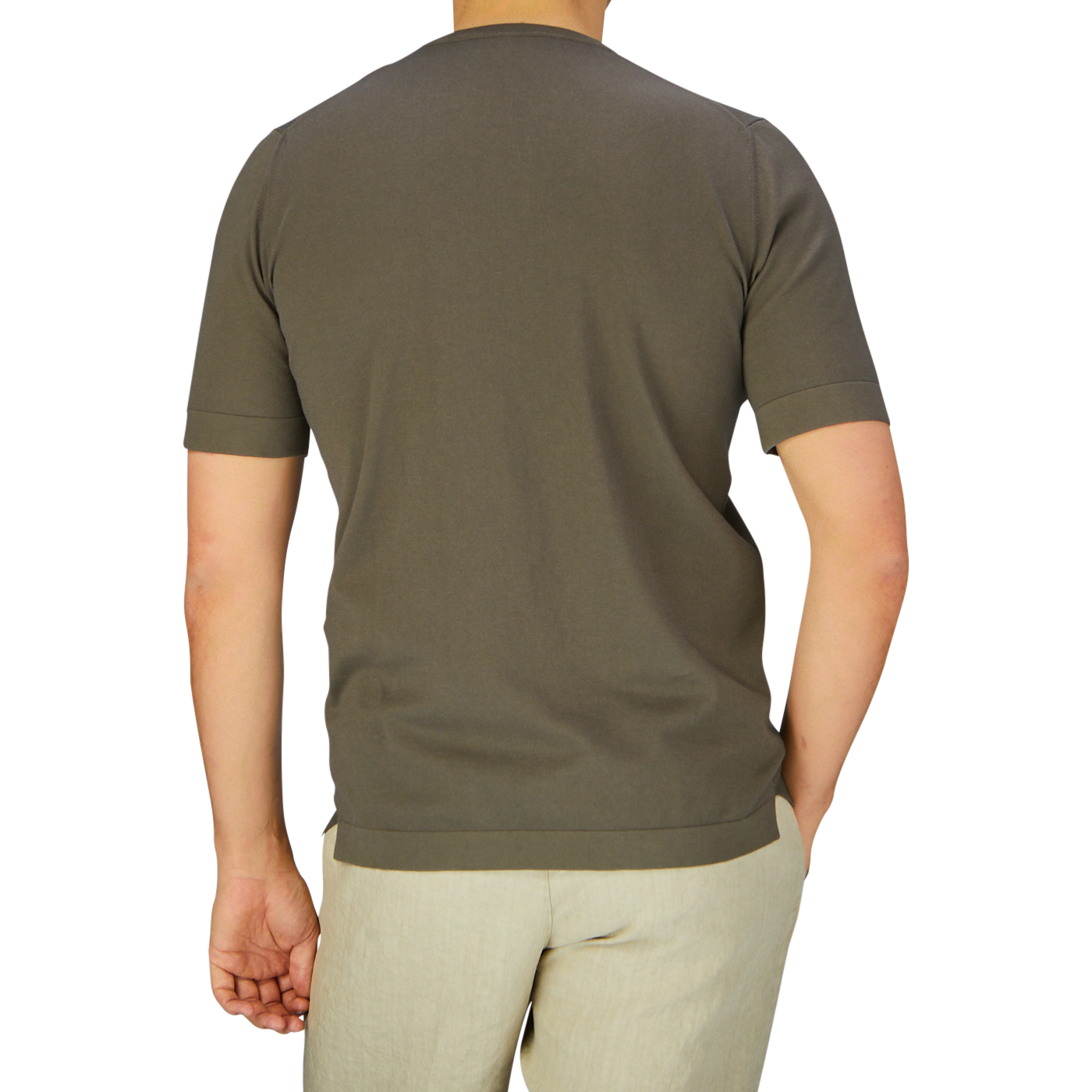 A person photographed from behind wearing a Gran Sasso olive green organic cotton t-shirt and cream-colored pants against a neutral background.