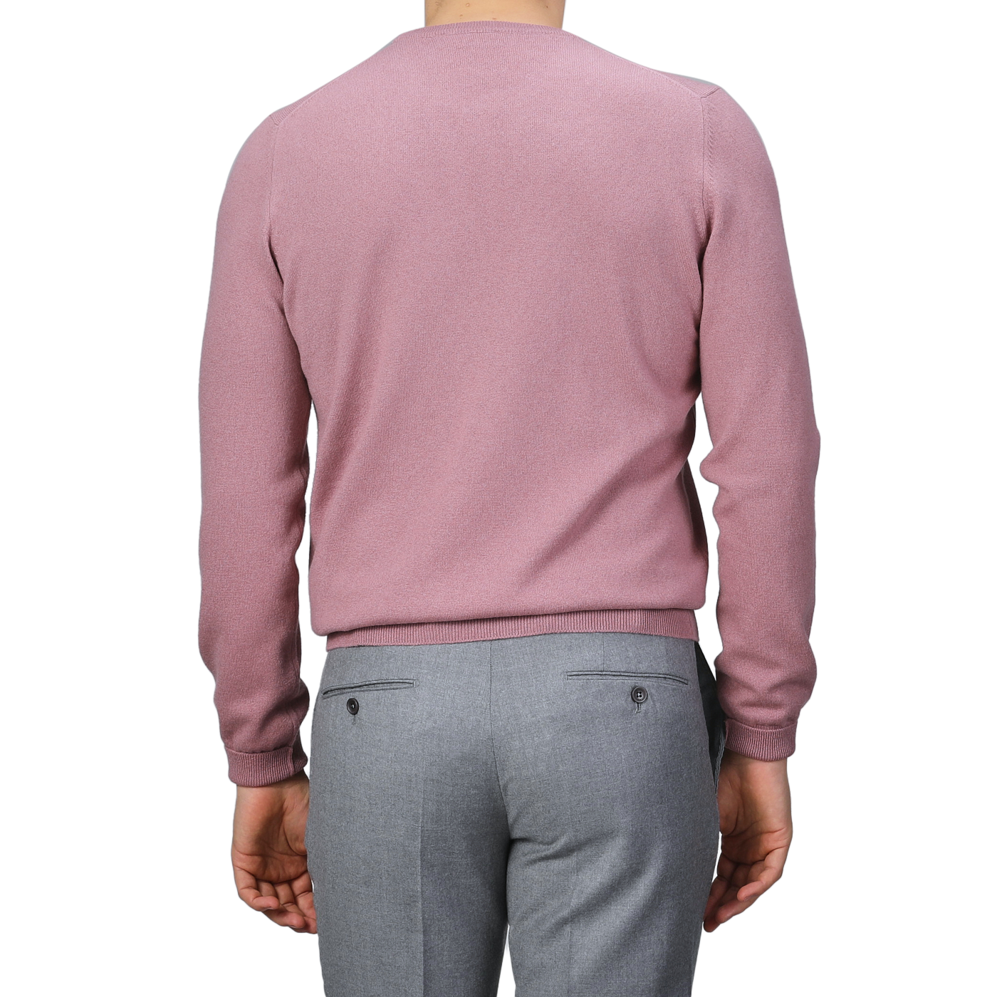 A person wearing a Gran Sasso Pale Pink Cashmere Crewneck Sweater and gray pants, photographed from the back against a gray background, embodies the elegance of sustainable knitwear.