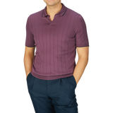 A man wearing a Gran Sasso Plum Knitted Silk Polo Shirt and blue pants.