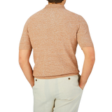 The back view of a man wearing a Gran Sasso Rust Orange Cotton Linen Polo Shirt.