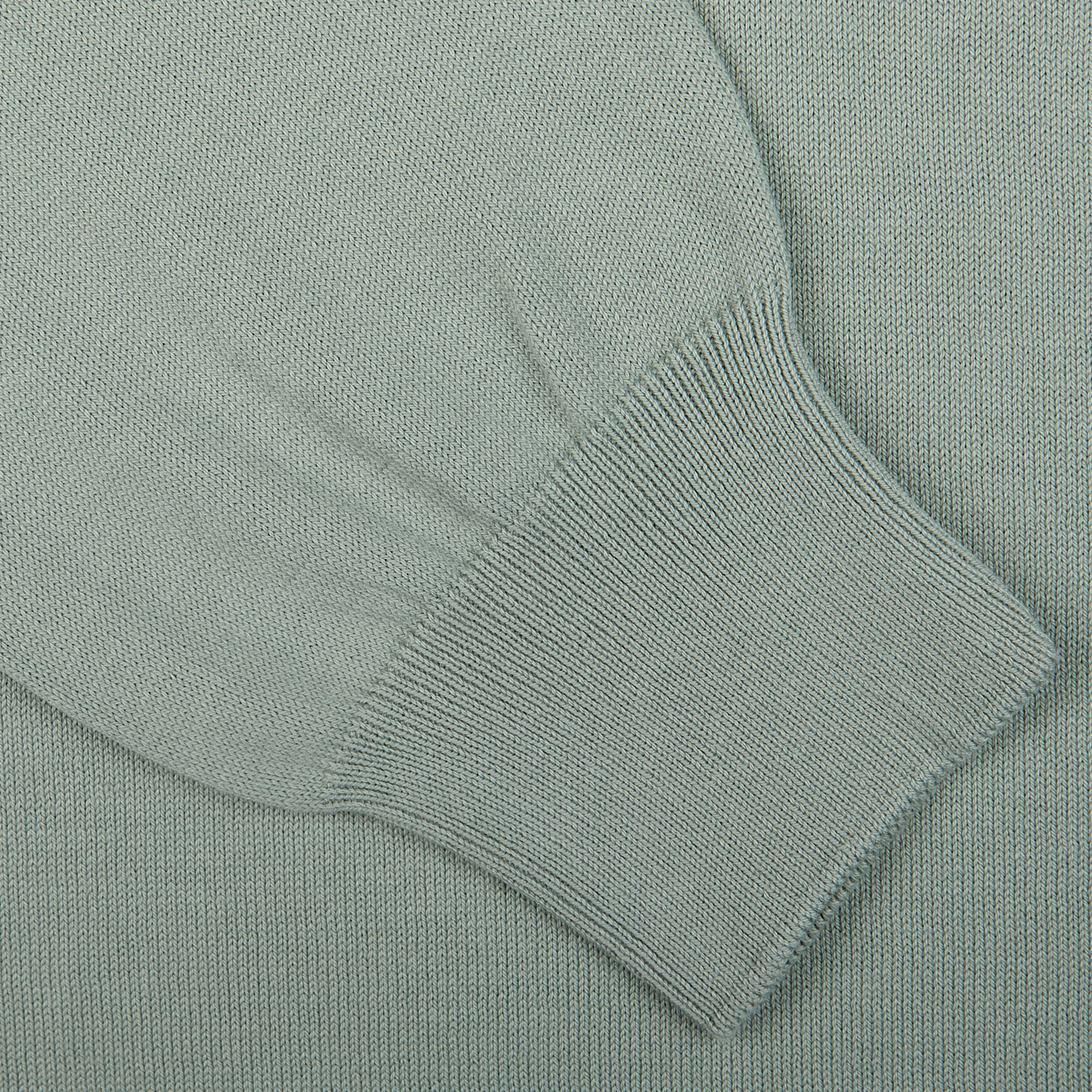 Close-up of a Gran Sasso Sage Green Egyptian Cotton 1/4 Zip Sweater fabric with a ribbed cuff detail.