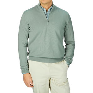 Man wearing a slim fit Gran Sasso Sage Green Egyptian Cotton 1/4 Zip Sweater and cream trousers.