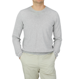 A man wearing a Silver Grey Silk Cotton Crewneck Sweater by Gran Sasso in a summer version.