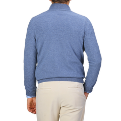 A person wearing a Gran Sasso Sky Blue Cashmere 1/4 Zip Sweater and beige pants stands facing away.