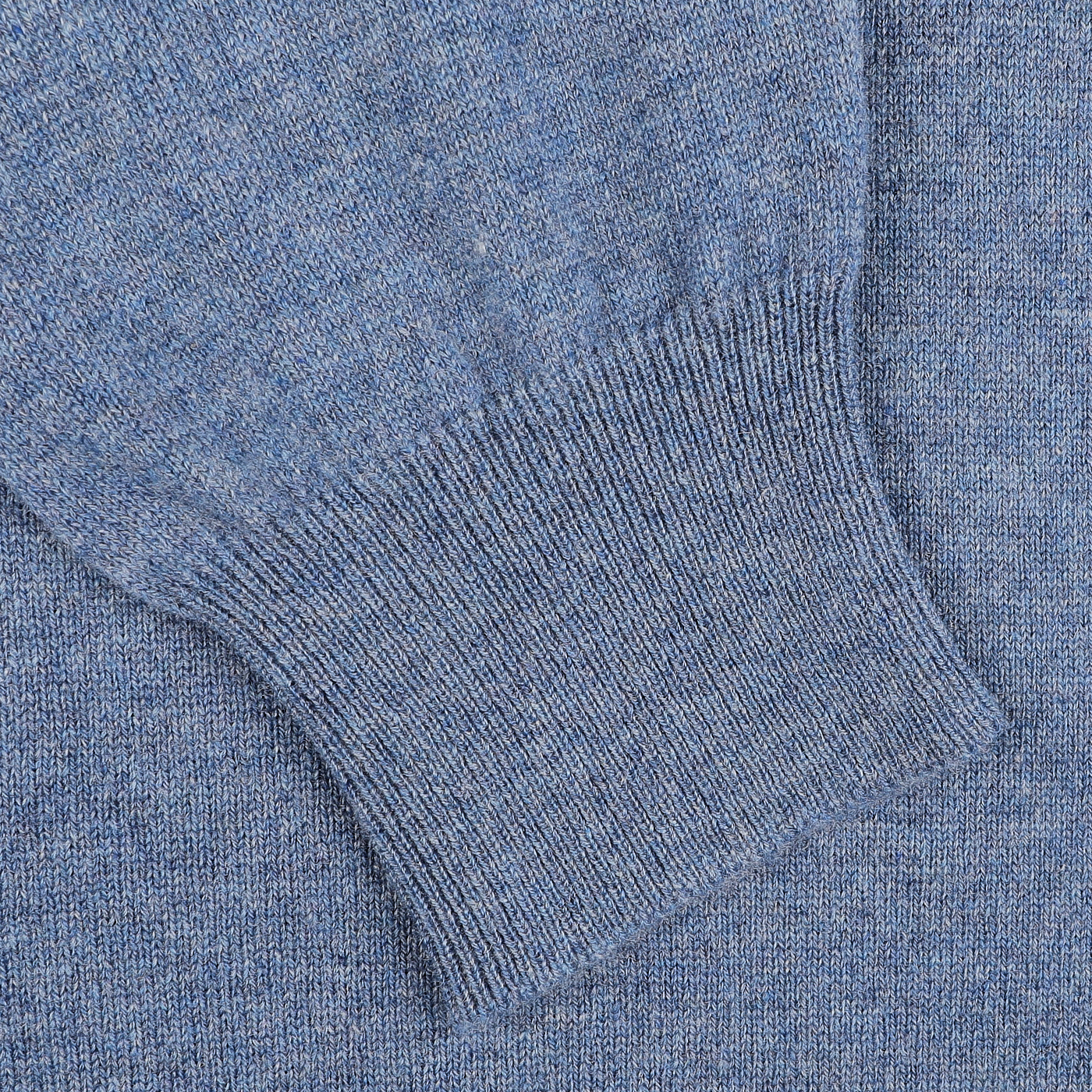 A close-up of the Sky Blue Cashmere 1/4 Zip Sweater by Gran Sasso reveals the ribbed cuff detail, highlighting the charm of premium knitwear.