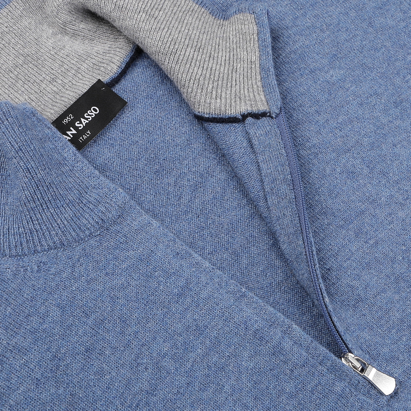 Close-up of a premium knitwear piece by Gran Sasso: the Sky Blue Cashmere 1/4 Zip Sweater, featuring a gray ribbed collar and a black inner label.