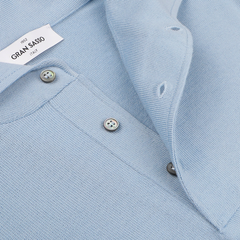 Close-up of a Sky Blue Merino Wool One-Piece Collar Polo Shirt featuring buttons. The visible label reads "Gran Sasso, Italy.