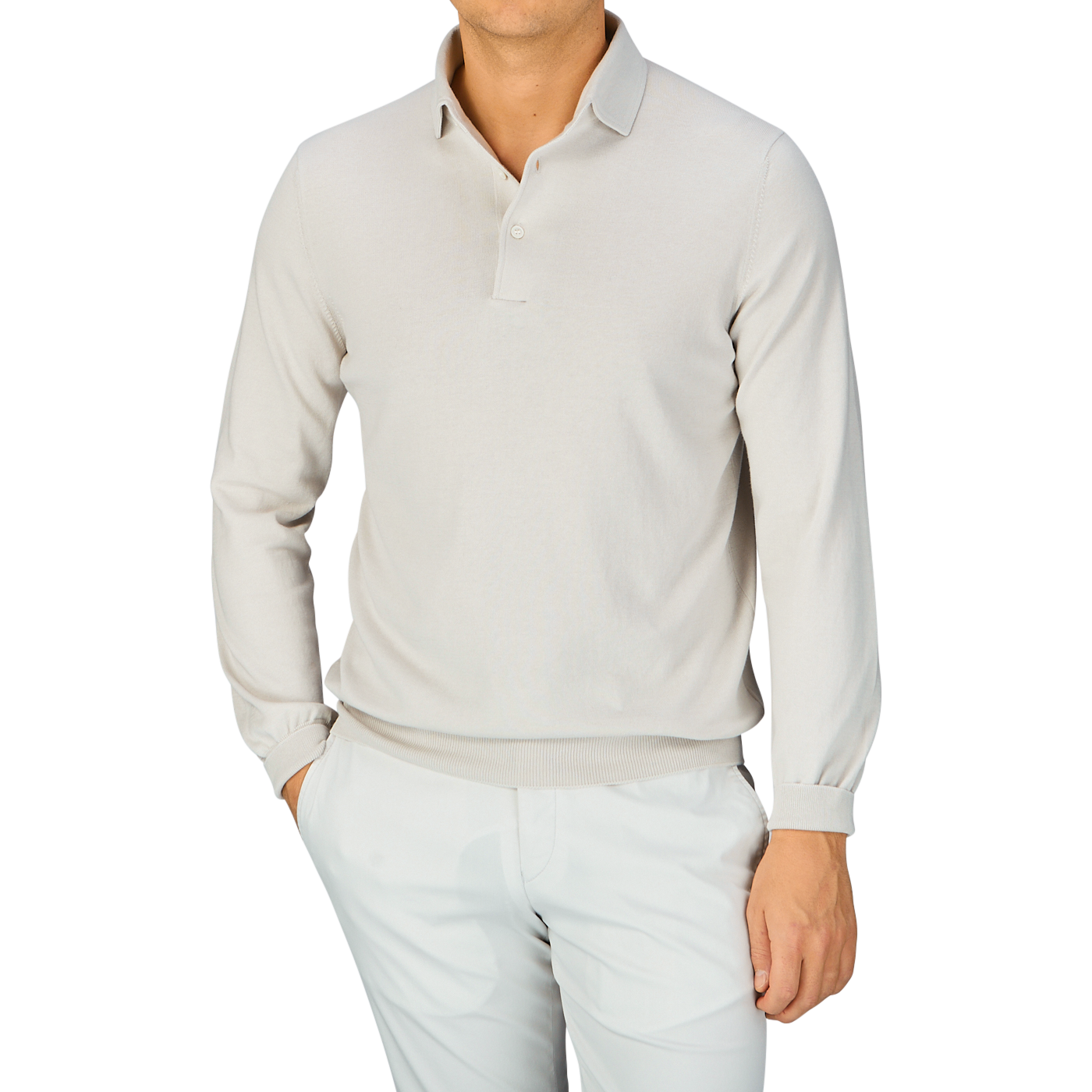 Man wearing a Taupe Beige Organic Cotton LS Polo Shirt by Gran Sasso and white pants against a blue background.