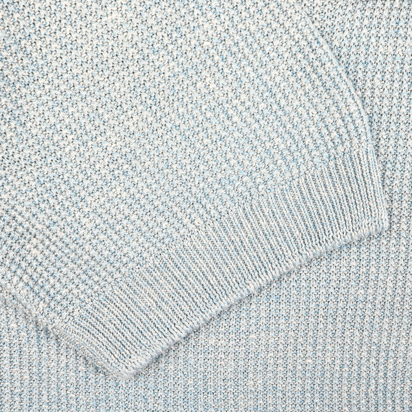 Close-up of a turquoise cotton linen polo shirt by Gran Sasso, highlighting its textured fabric and detailed stitching.