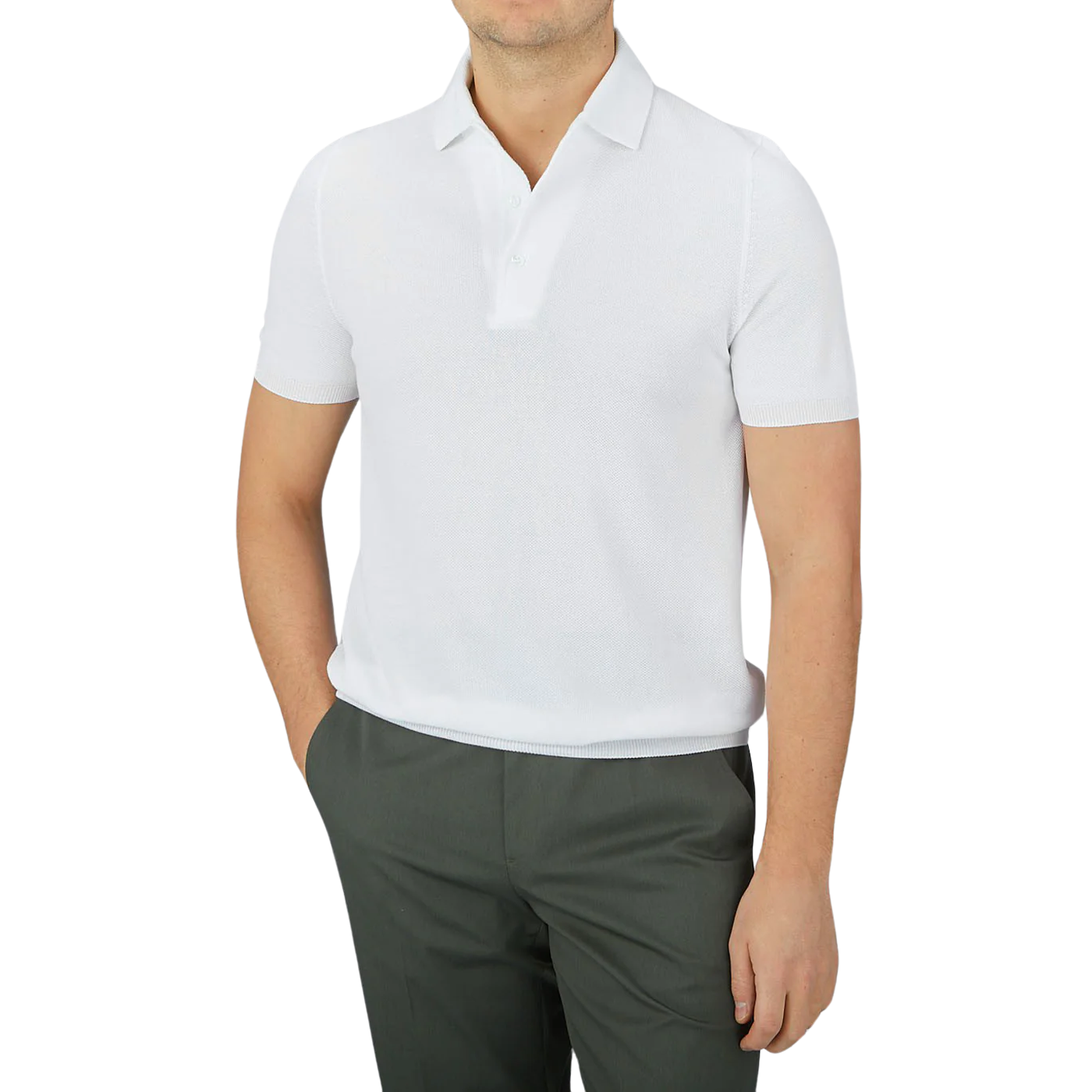 A man wears a Gran Sasso White Fresh Cotton Mesh Polo Shirt, known for its breathability, paired with dark pants and stands with hands in pockets.