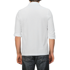 A person wearing a White Washed Cotton Popover Shirt by Gran Sasso and dark jeans, viewed from the back.