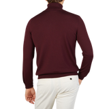 The back view of a man wearing a Gran Sasso Wine Melange Extra Fine Merino Roll Neck made of super soft extra fine wool.