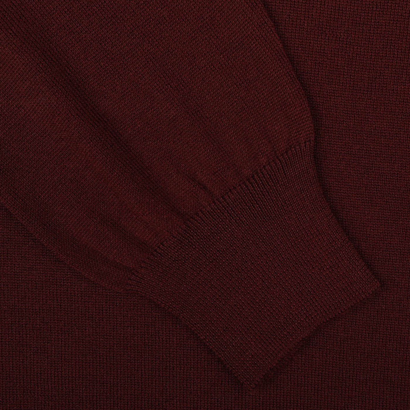 Close-up of the Gran Sasso Wine Melange Extra Fine Merino Roll Neck, highlighting a portion of the sleeve with ribbed cuffs.