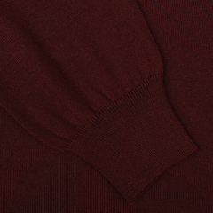 Close-up of the Gran Sasso Wine Melange Extra Fine Merino Roll Neck, highlighting a portion of the sleeve with ribbed cuffs.