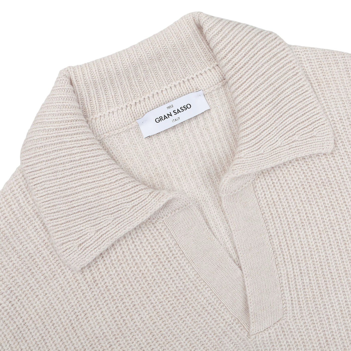 Close-up of an Ecru Beige Chunky Knit Wool Polo Shirt by Gran Sasso, made from super Geelong wool, featuring a folded collar and a label inside that reads "Gran Sasso.