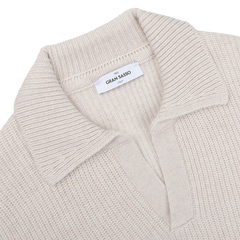 Close-up of an Ecru Beige Chunky Knit Wool Polo Shirt by Gran Sasso, made from super Geelong wool, featuring a folded collar and a label inside that reads "Gran Sasso.