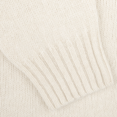 Close-up of an Almond White Extrafine Lambswool Rollneck sleeve with ribbed cuff detail, showcasing the timeless craftsmanship of Harley of Scotland.