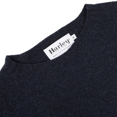 Close-up of a Cosmos Blue Extrafine Lambswool Crewneck with a label reading "Harley of Scotland, Made in Scotland.